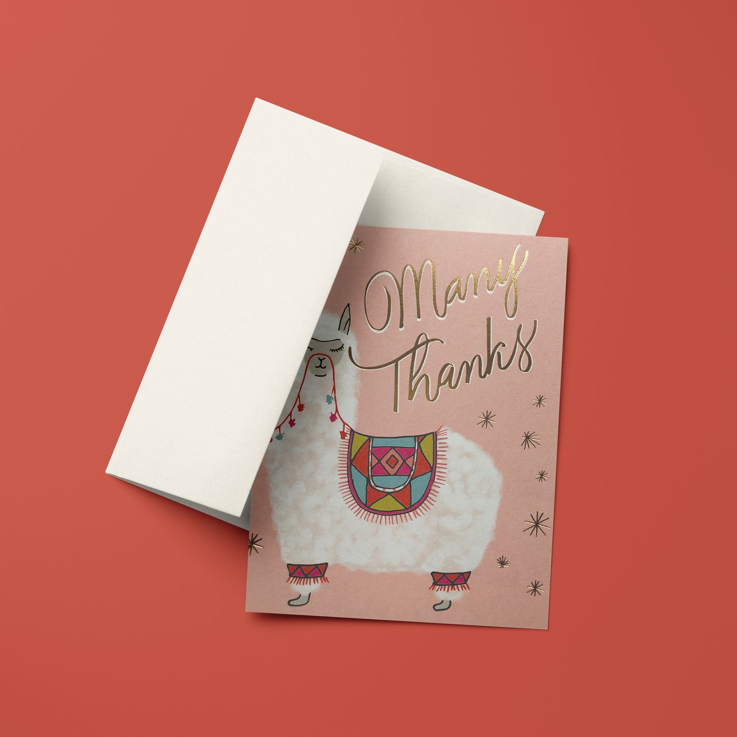 Thank you card featuring a cute alpaca illustration with a colorful blanket and "many Thanks" in gold foil.