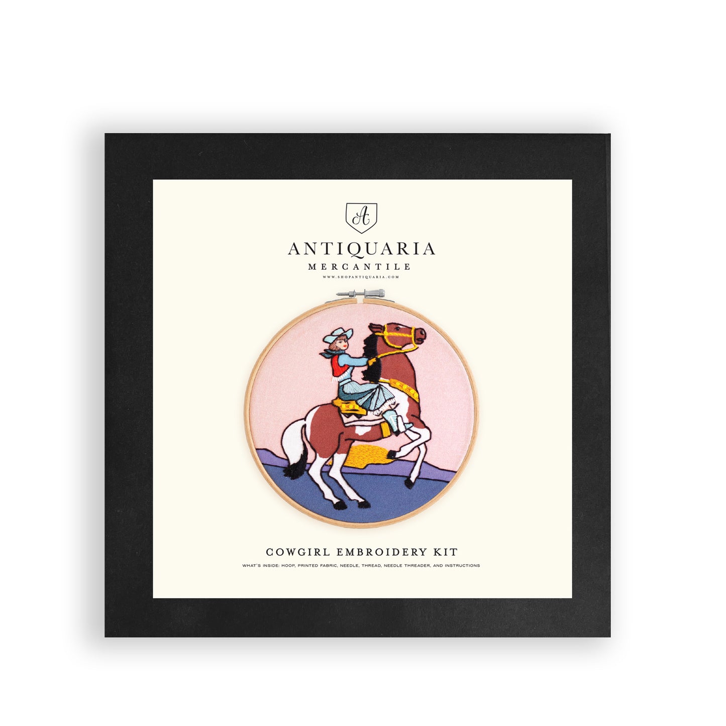 Embroidery kit with fabric, wooden hoop, thread, needle, and instructions for beginners, featuring a cowgirl riding a horse during sunset