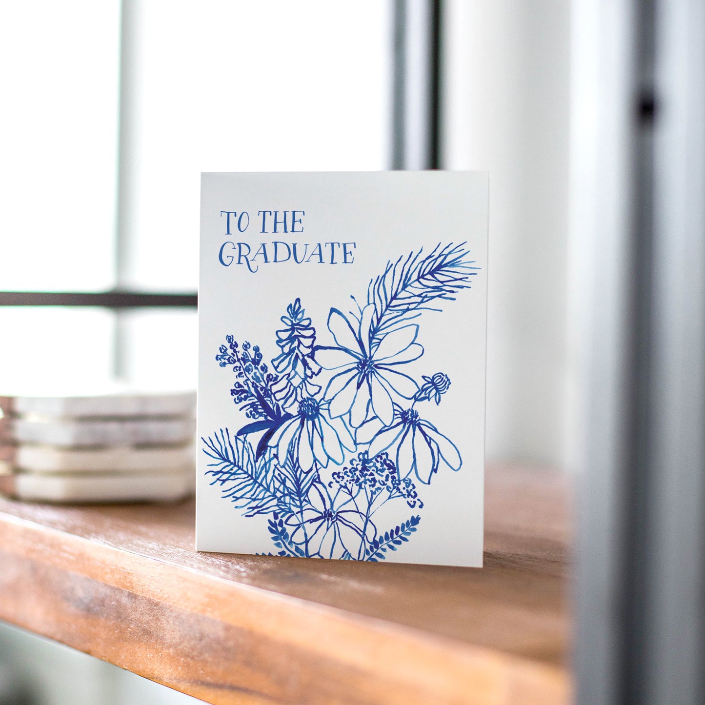 Indigo Wildflowers Graduate card with a botanical design, perfect for congratulating graduates