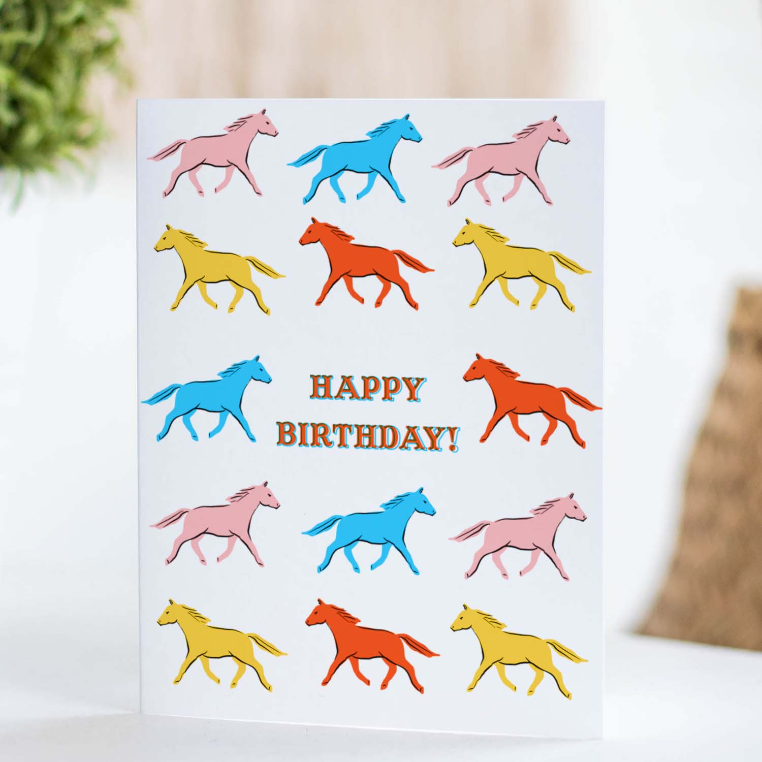 Rustic birthday card featuring a colorful illustration of horses, celebrating the spirit of the wild.