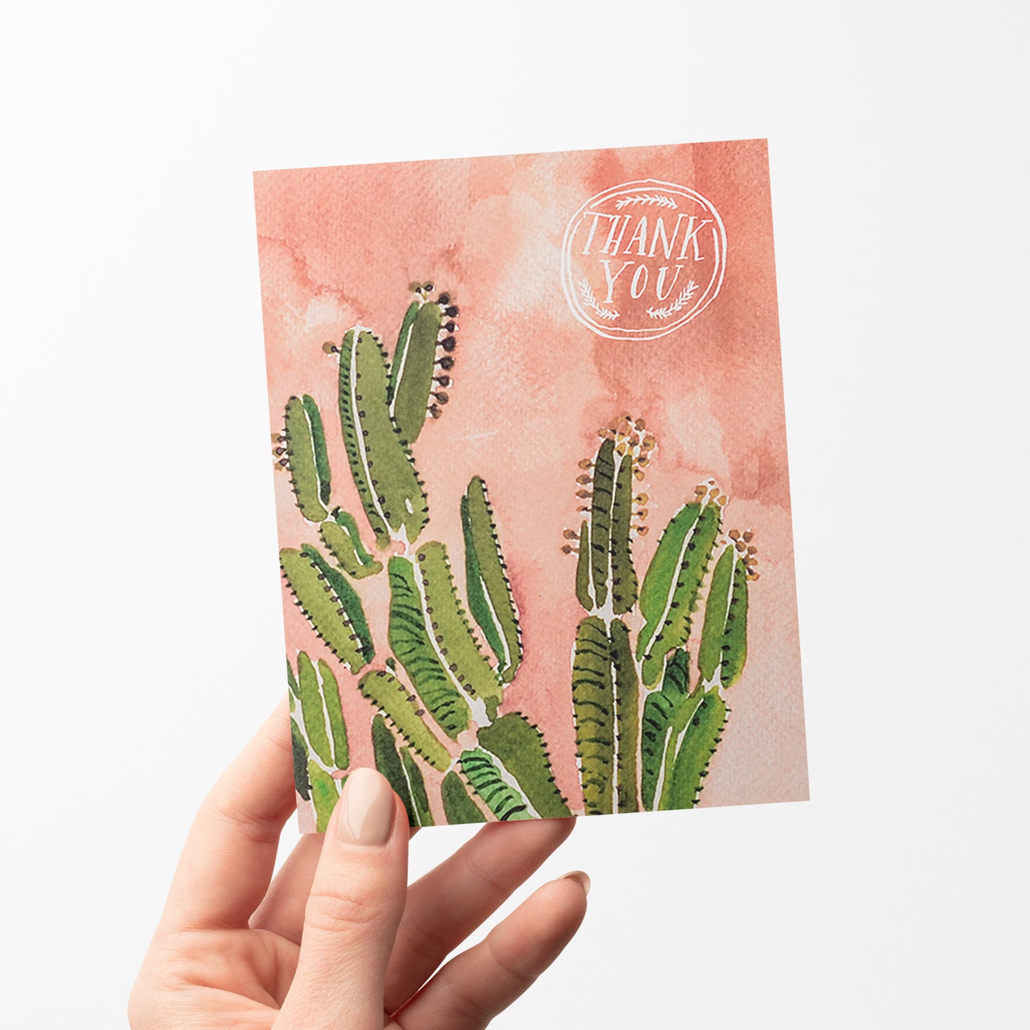 Thank you card featuring a coral-colored background and beautiful watercolor cactus illustration with warm desert tones.