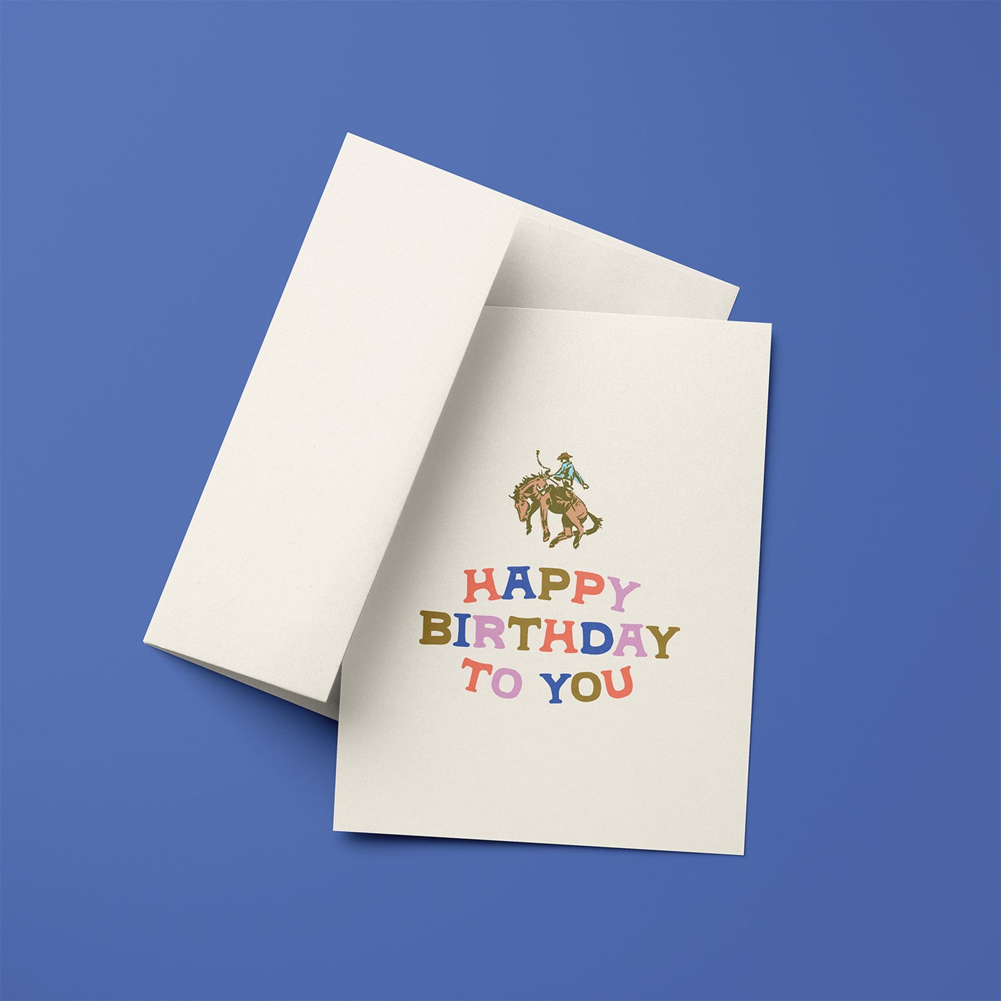 Birthday card with a cowboy riding a horse and colorful 'Happy Birthday To You' text