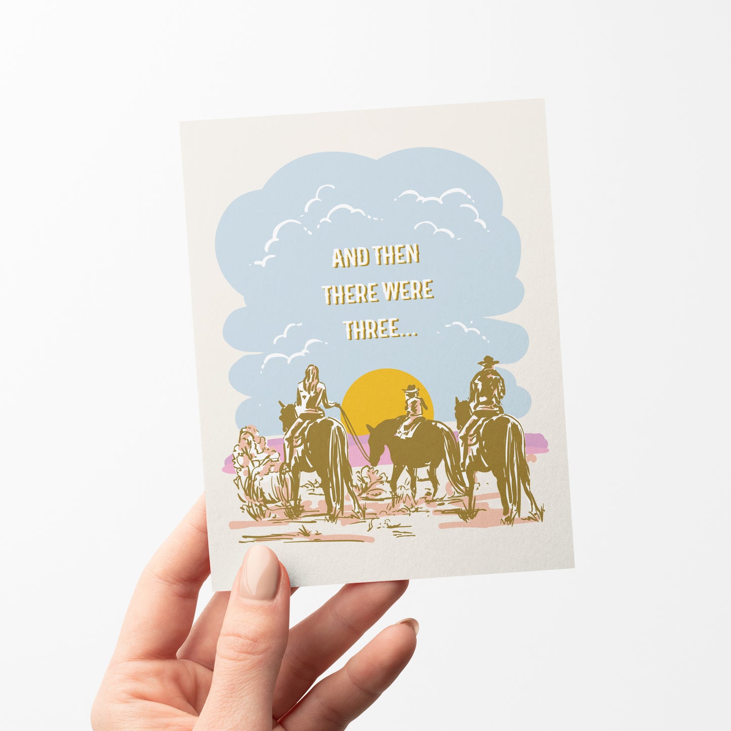 A beautifully illustrated greeting card featuring a desert landscape with two parents on horseback taking their little one on a trail ride. The warm, earthy tones capture the spirit of the Wild West, making it a perfect card for celebrating new babies, growing families, or Western-themed occasions