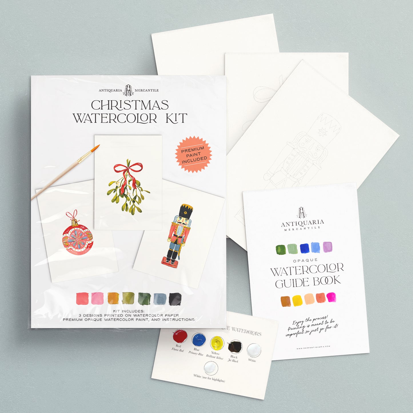 Christmas watercolor kit with guide book on a gray background