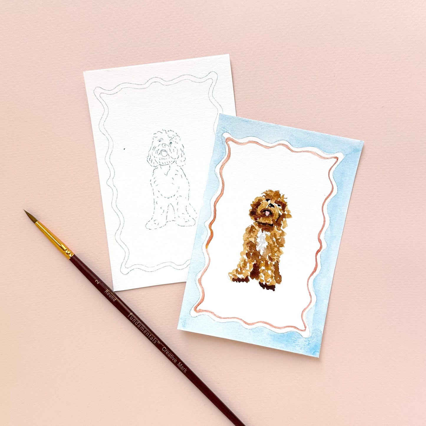 Two greeting cards with dog illustrations and a paintbrush on a beige background