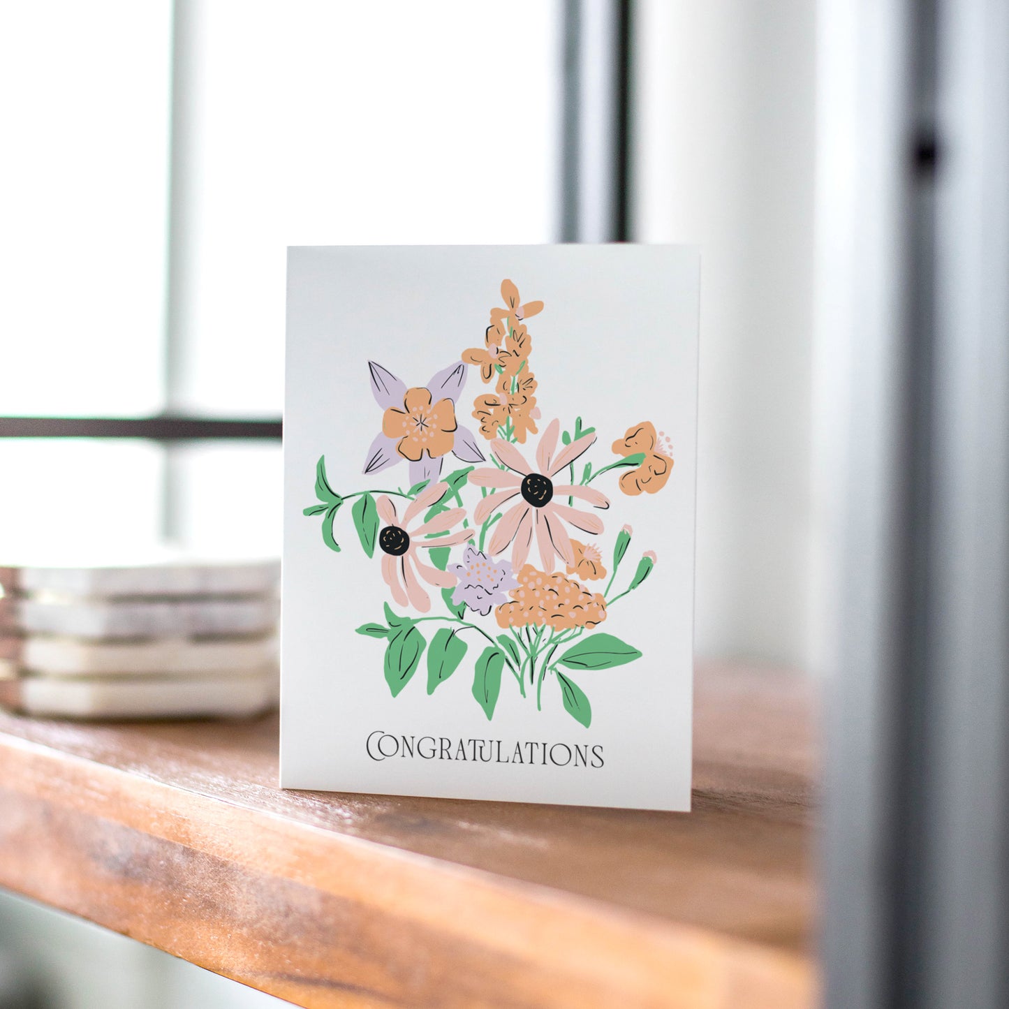 A beautifully illustrated greeting card featuring a bouquet of hand-drawn flowers in soft peach, lavender, and green hues. The card showcases the elegant text "Congratulations" in a refined font, making it a perfect choice for celebrating special achievements, weddings, promotions, or milestones.