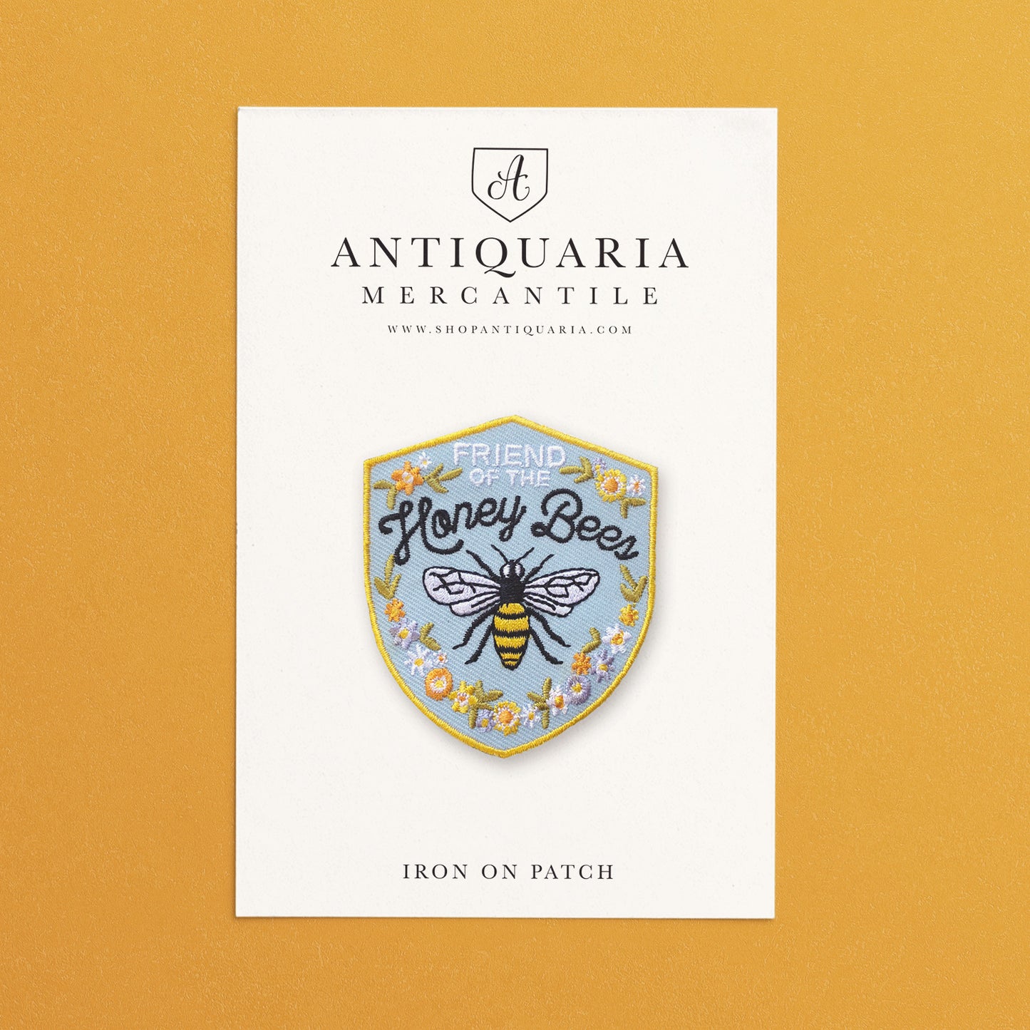 Friend of the Honey Bee embroidered iron-on patch featuring Bees, and flowers, perfect for jackets, bags, or hats to support pollinator conservation.