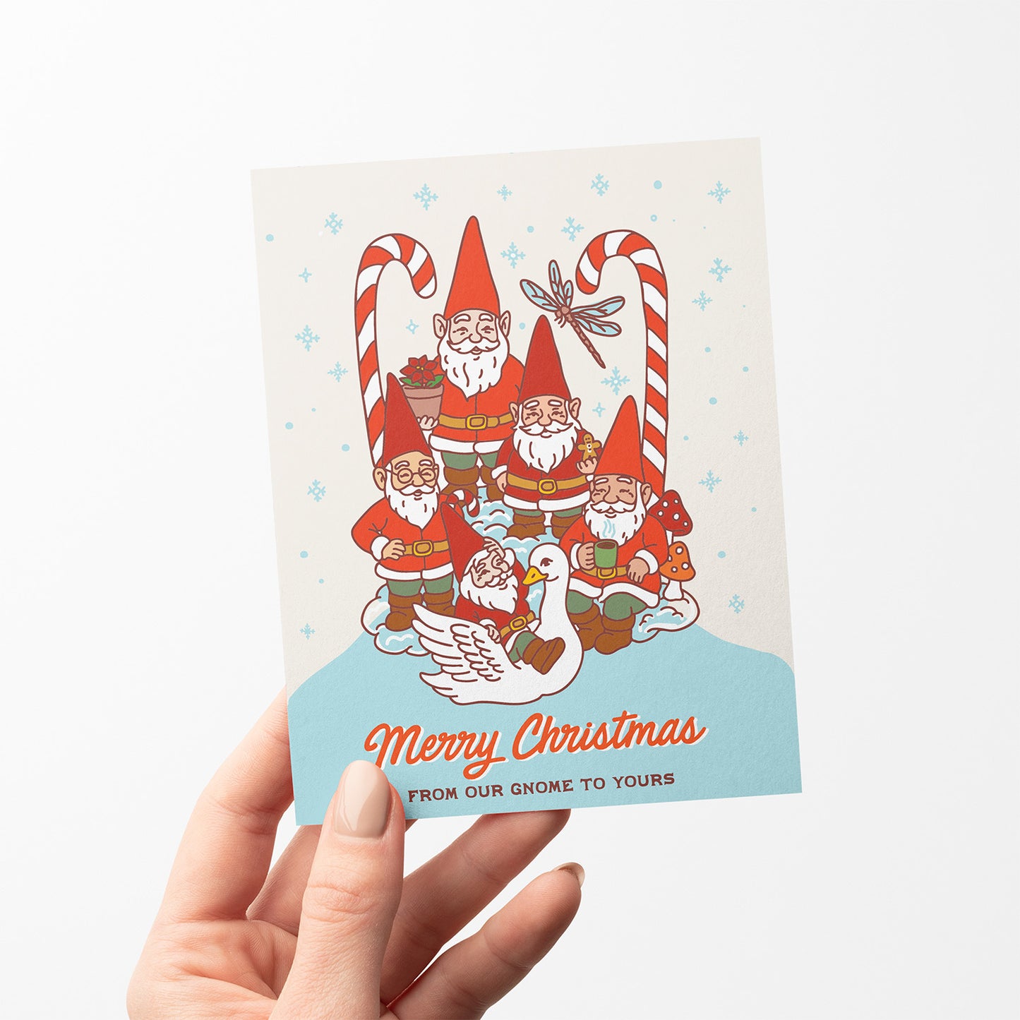 Christmas card with garden gnomes, candy canes, snowy background, and the text “Merry Christmas from our gnome to yours.”