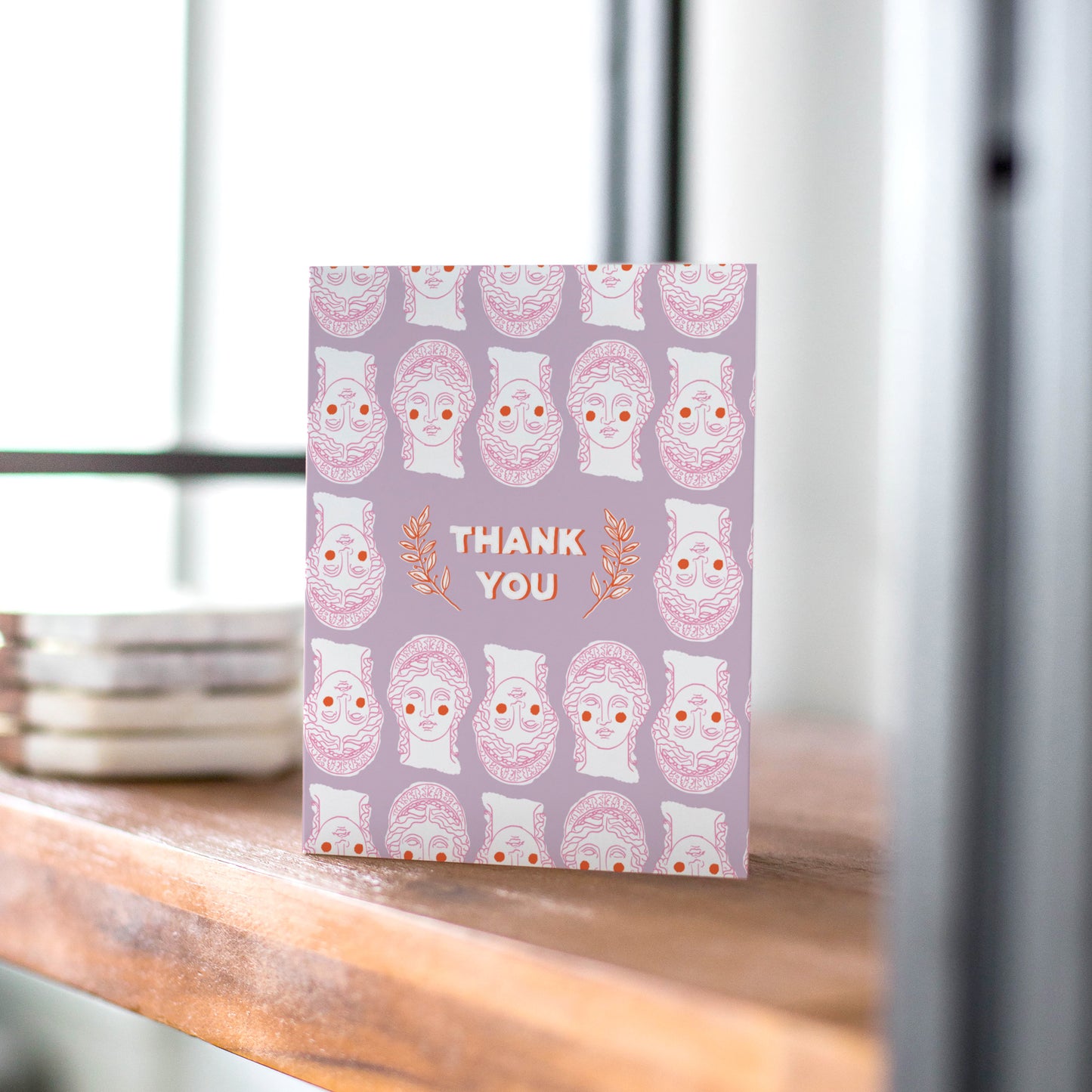 Thank you card with a Grecian-inspired design featuring classic Greek bust in a fun pattern on a purple background.