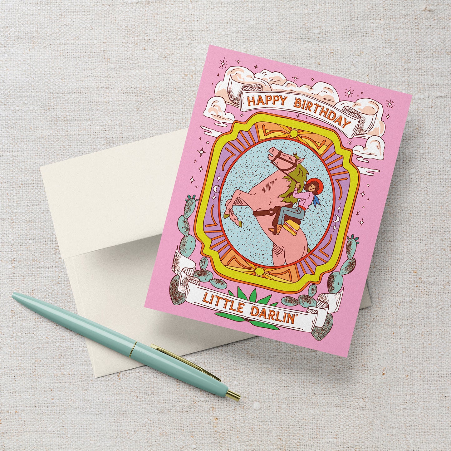 Western-themed pink birthday card with cowgirl riding a horse and the text “Happy Birthday Little Darlin’.”