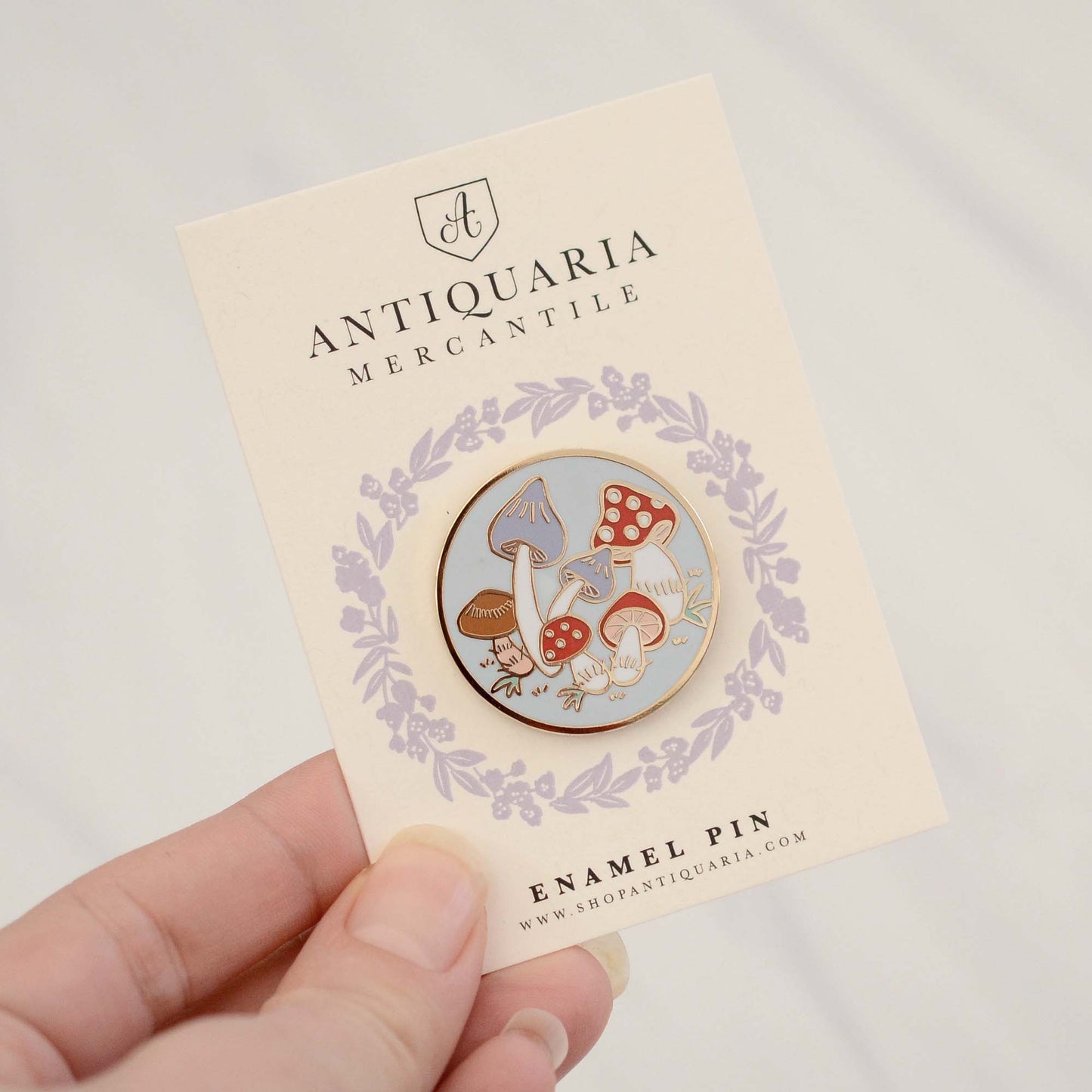 enamel pin featuring a group of colorful mushrooms with gold accents, perfect for decorating jackets, bags, or stationery items.