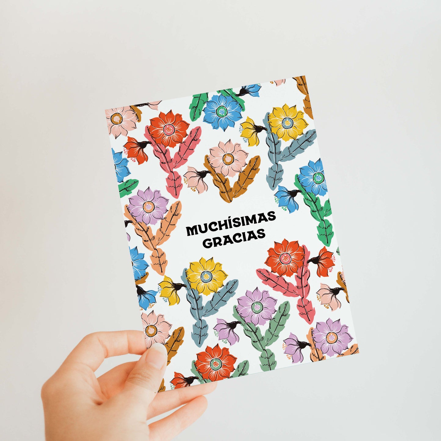 Thank you card with a unique orchid cactus illustration and 'Muchisimas Gracias' in modern font