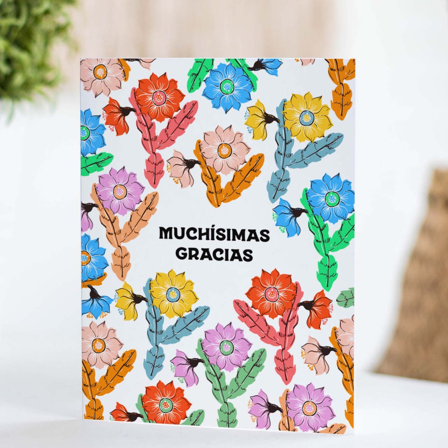 Thank you card with a unique orchid cactus illustration and 'Muchisimas Gracias' in modern font