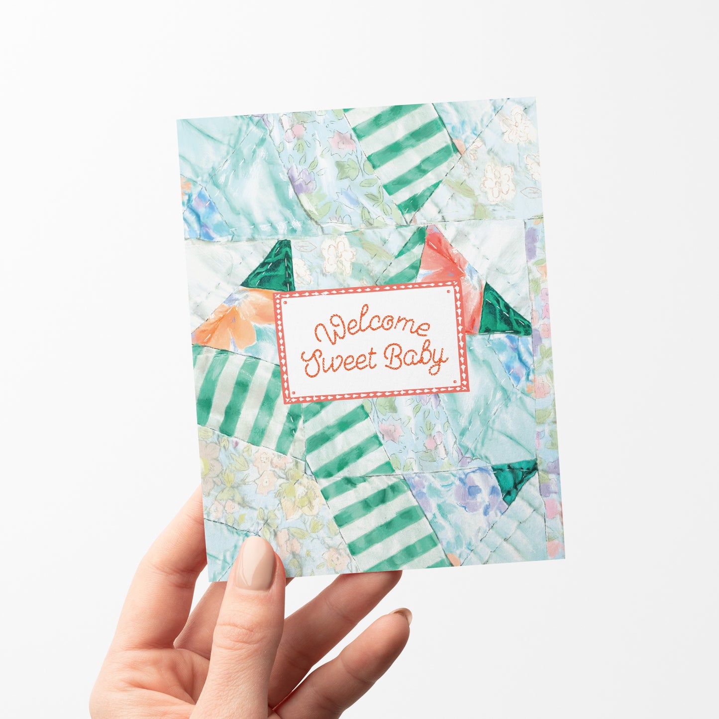 A charming greeting card featuring a quilt-inspired background with soft, patchwork patterns. The design includes a quilt tag with the message "Welcome Sweet Baby," making it a heartfelt choice for celebrating a new arrival. Perfect for baby showers and newborn gifts.