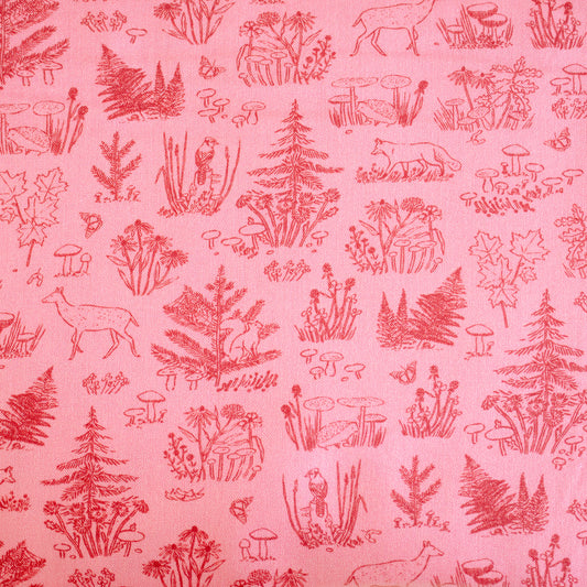 Pink fabric with red forest pattern including trees, animals, and plants.