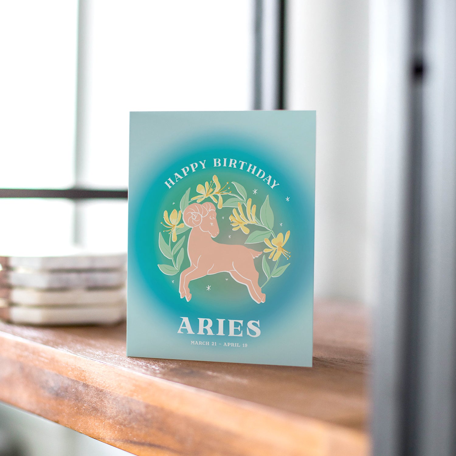 Dynamic birthday card featuring the Aries symbol with bright blues and bold designs, celebrating the adventurous and passionate spirit of Aries.