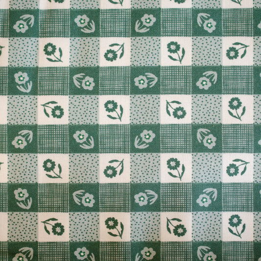 Green and white checkered fabric with floral patterns