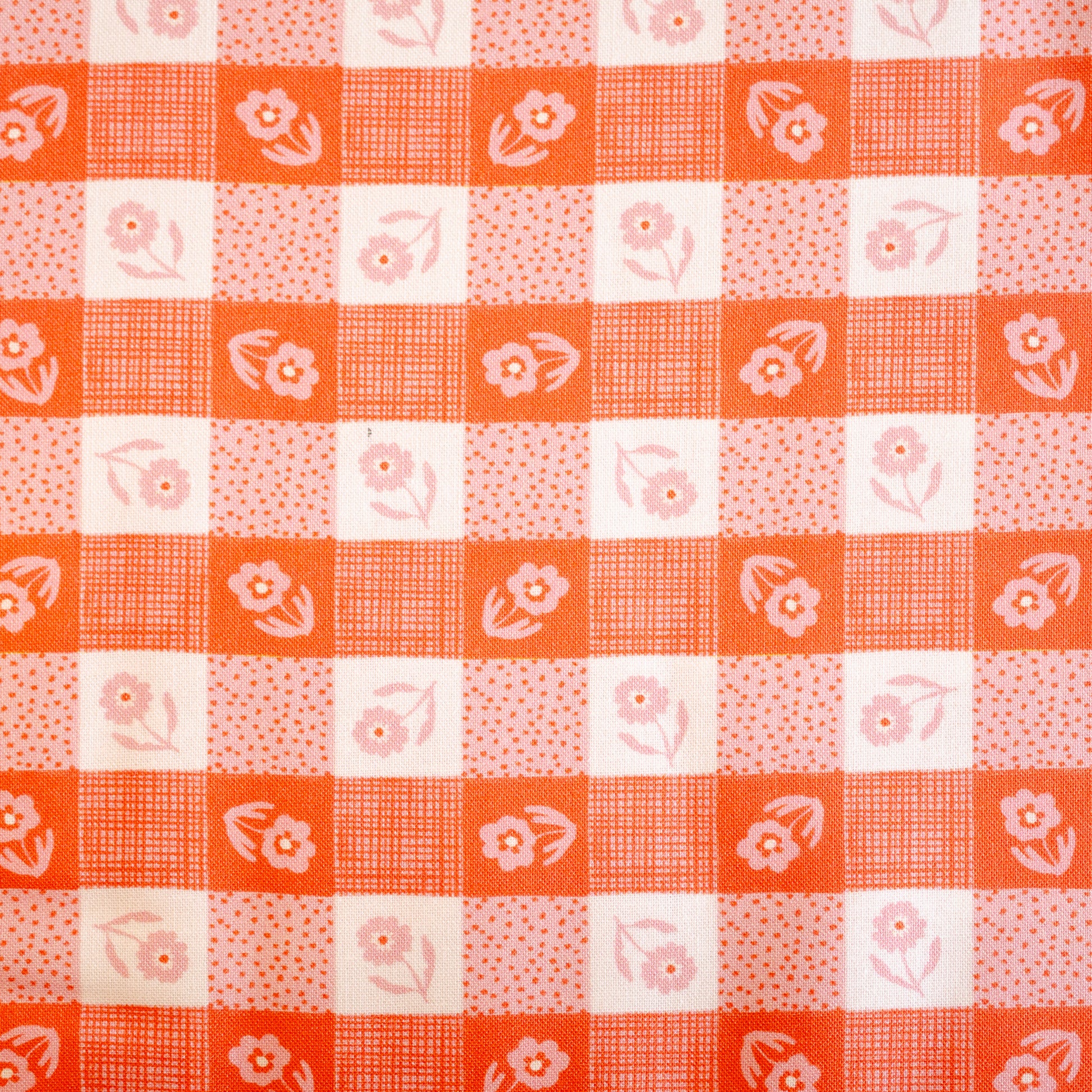 Checkered pattern with floral elements on a red and white background