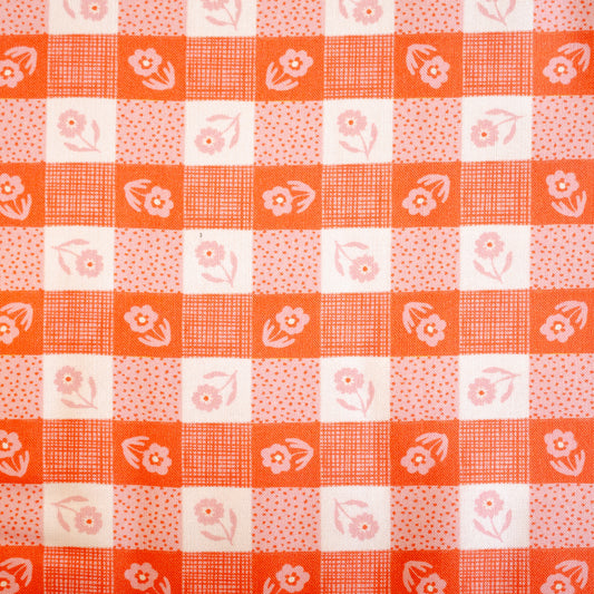 Checkered pattern with floral elements on a red and white background
