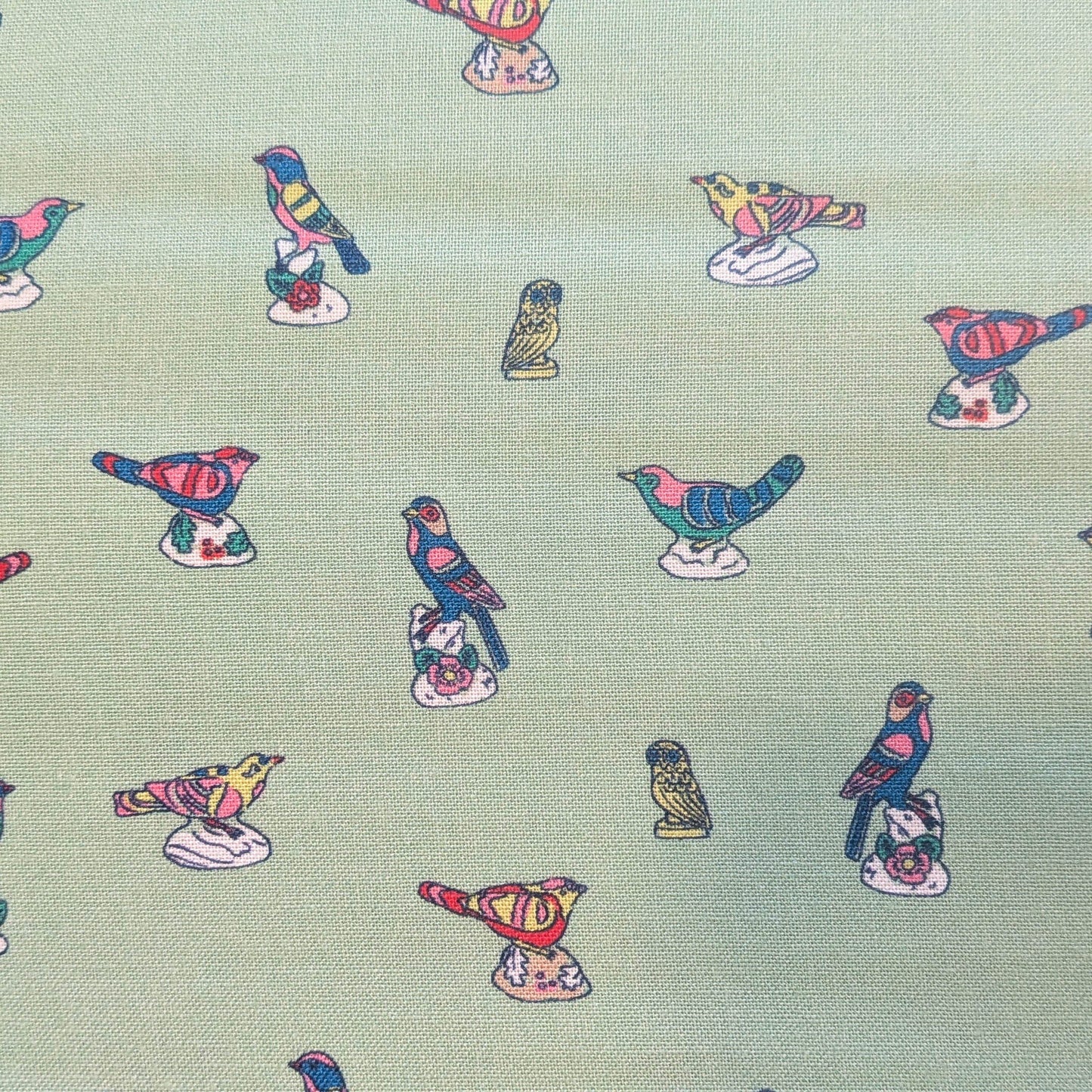 Pattern of colorful fish on a light green background