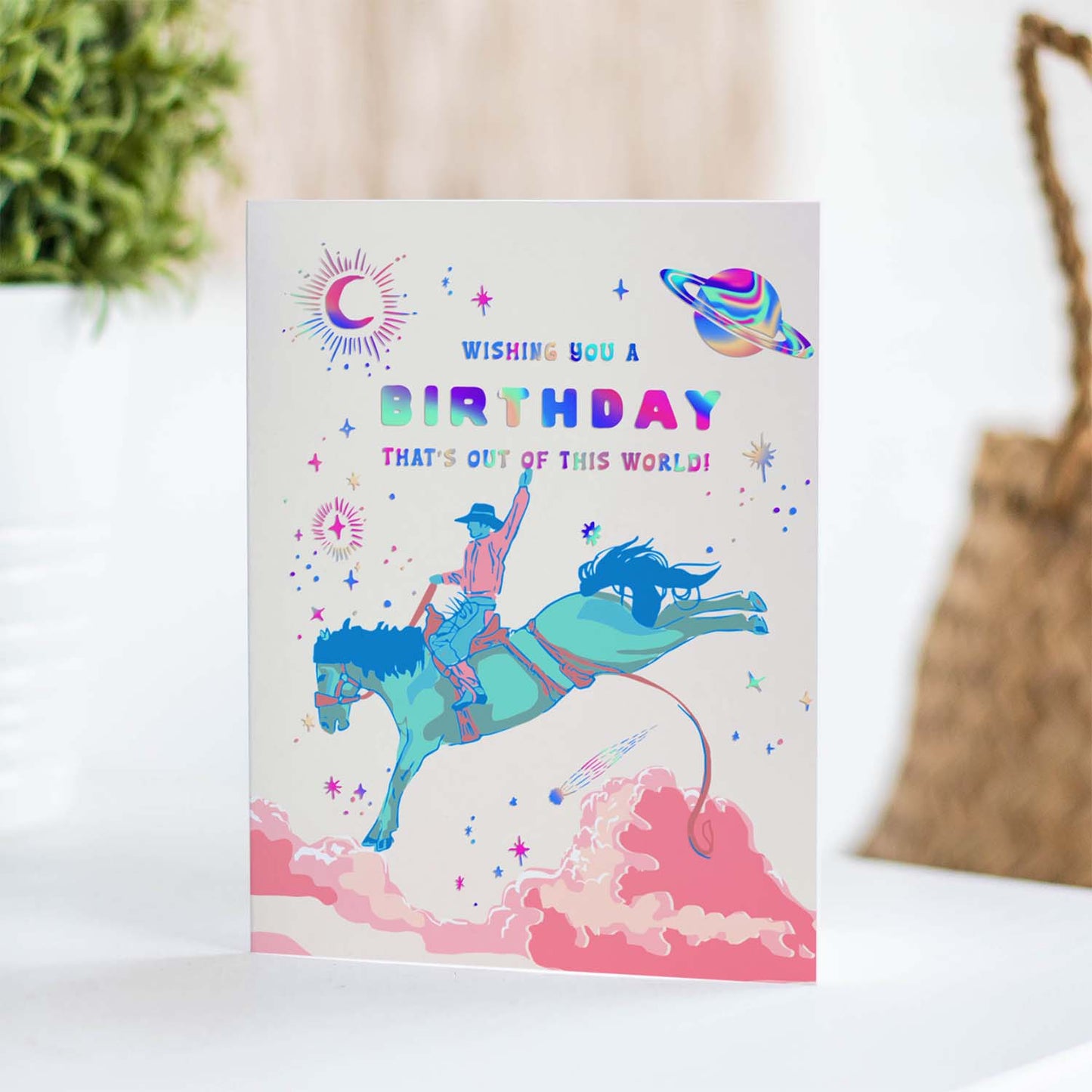 Unique birthday card blending cowboy elements with outer space, featuring stars, planets, and western motifs for a fun, cosmic celebration.