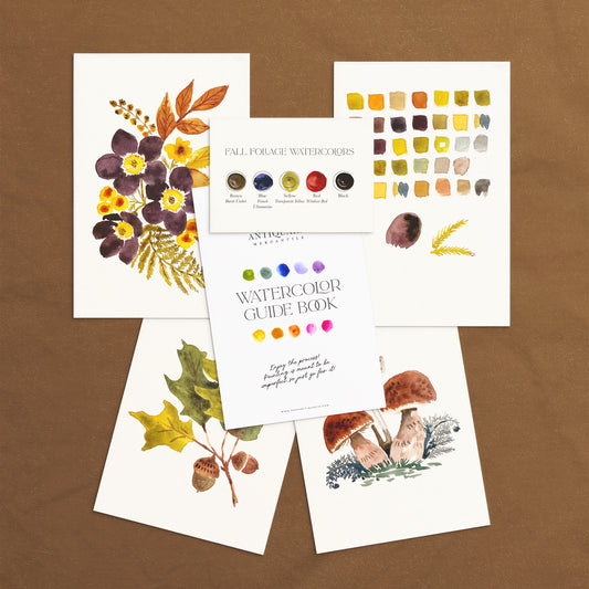 Collection of watercolor guides and color swatches on a brown background