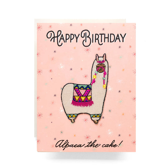 Birthday card featuring an adorable iron-on alpaca patch with colorful details and the saying alpaca the cake, perfect for animal lovers and a cozy celebration.