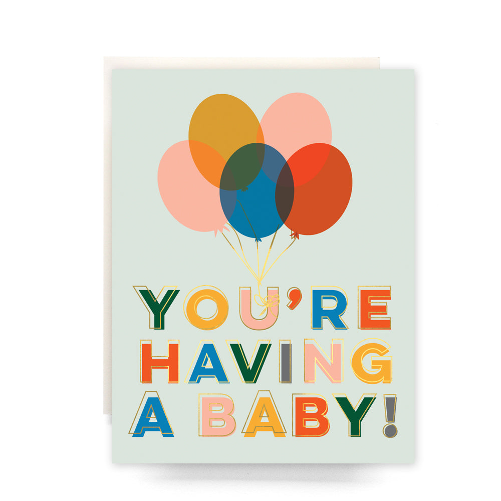 Colorful balloons with the text 'You're Having a Baby' on a blank greeting card.