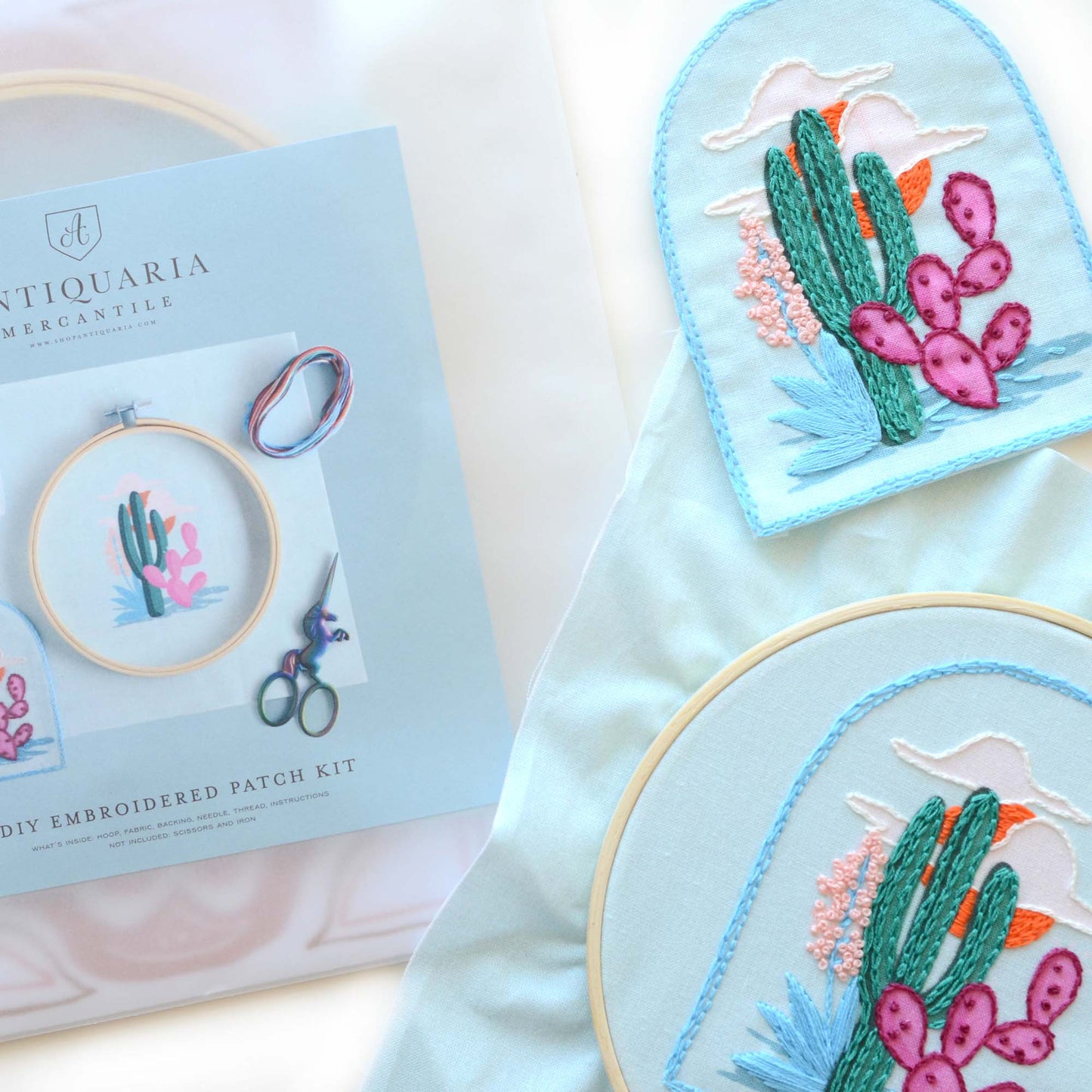 Embroidery patch kit with fabric, wooden hoop, thread, needle, and instructions for beginners, featuring a desert scape