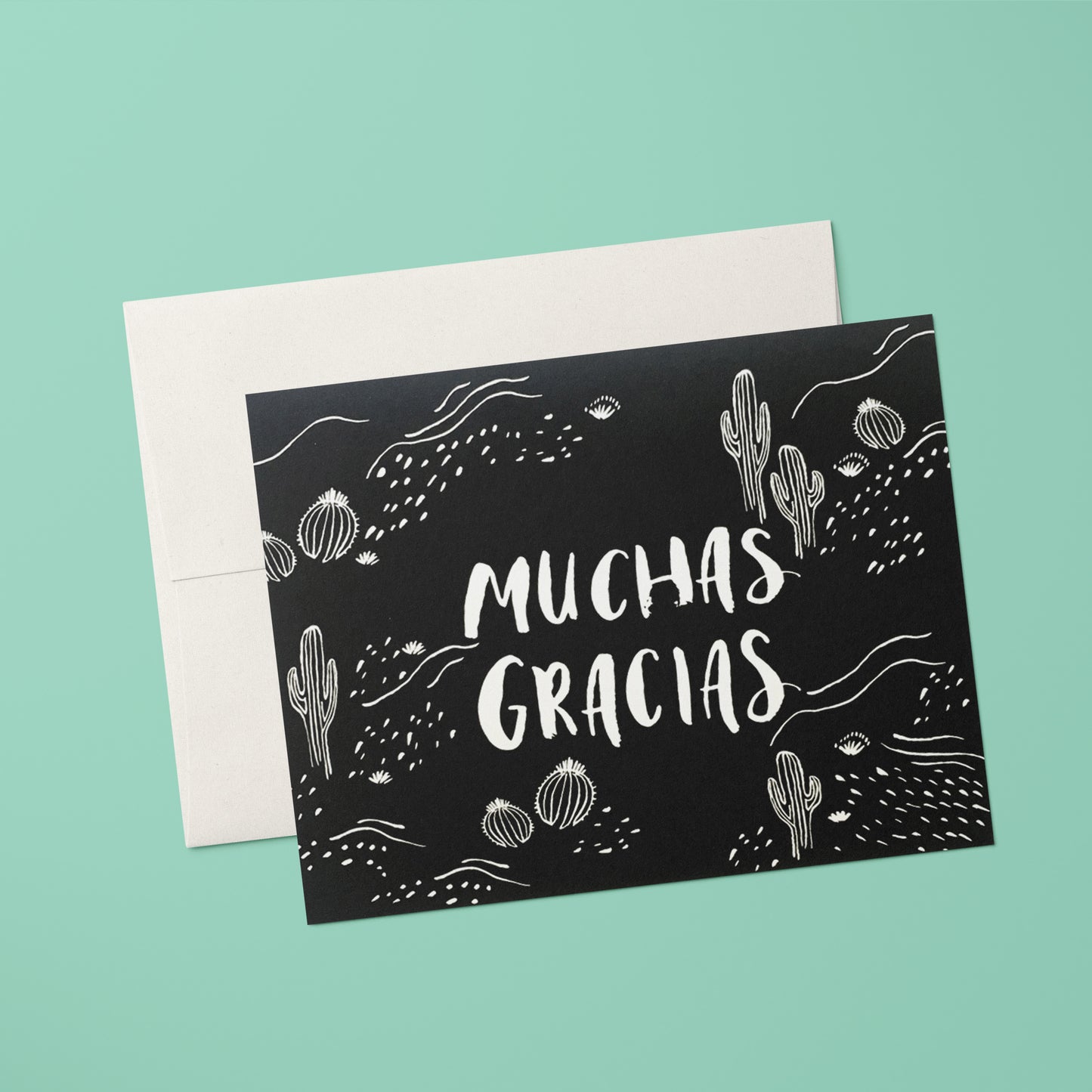 Thank you card with a black and white cactus illustrations and 'Muchas Gracias' in hand lettering