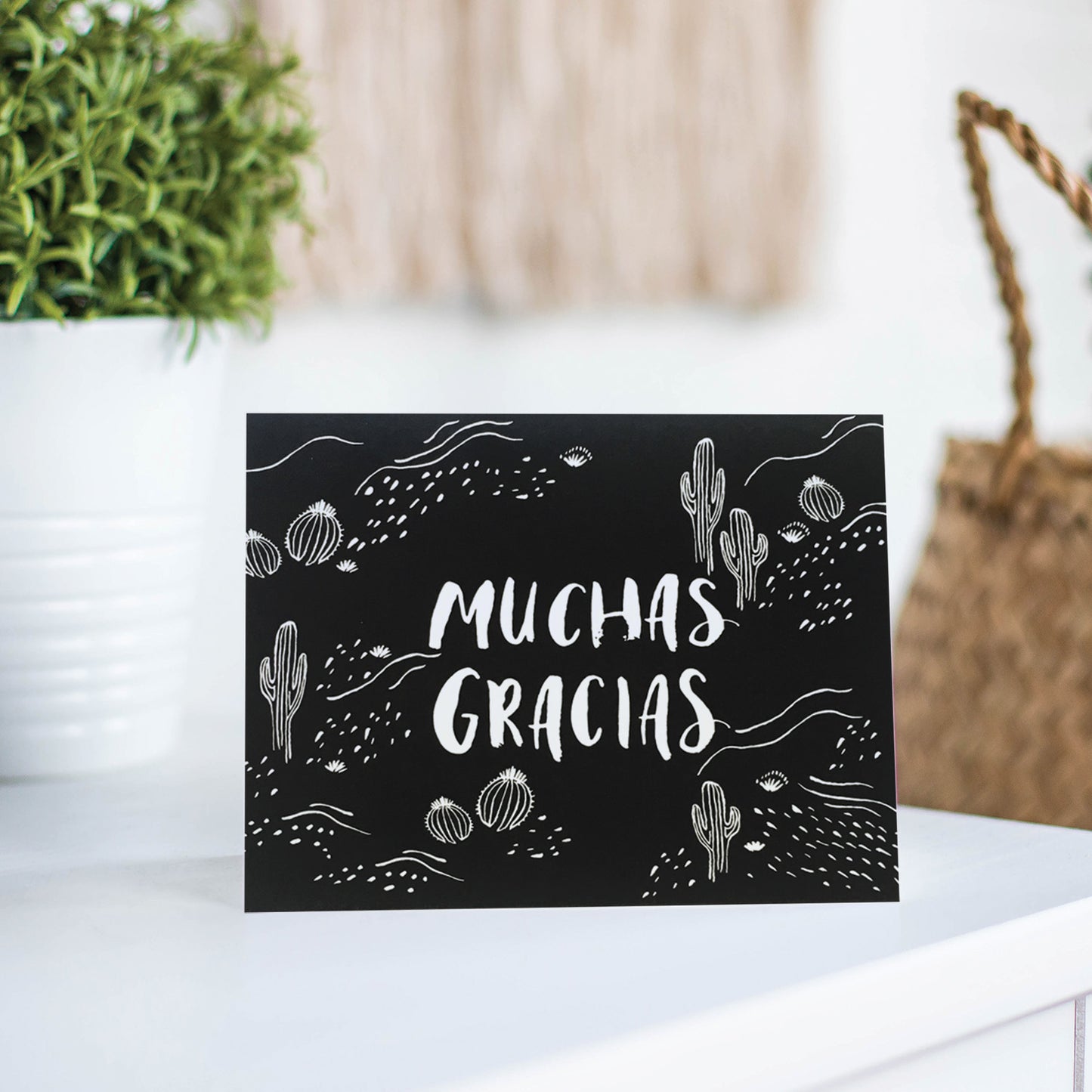 Thank you card with a black and white cactus illustrations and 'Muchas Gracias' in hand lettering