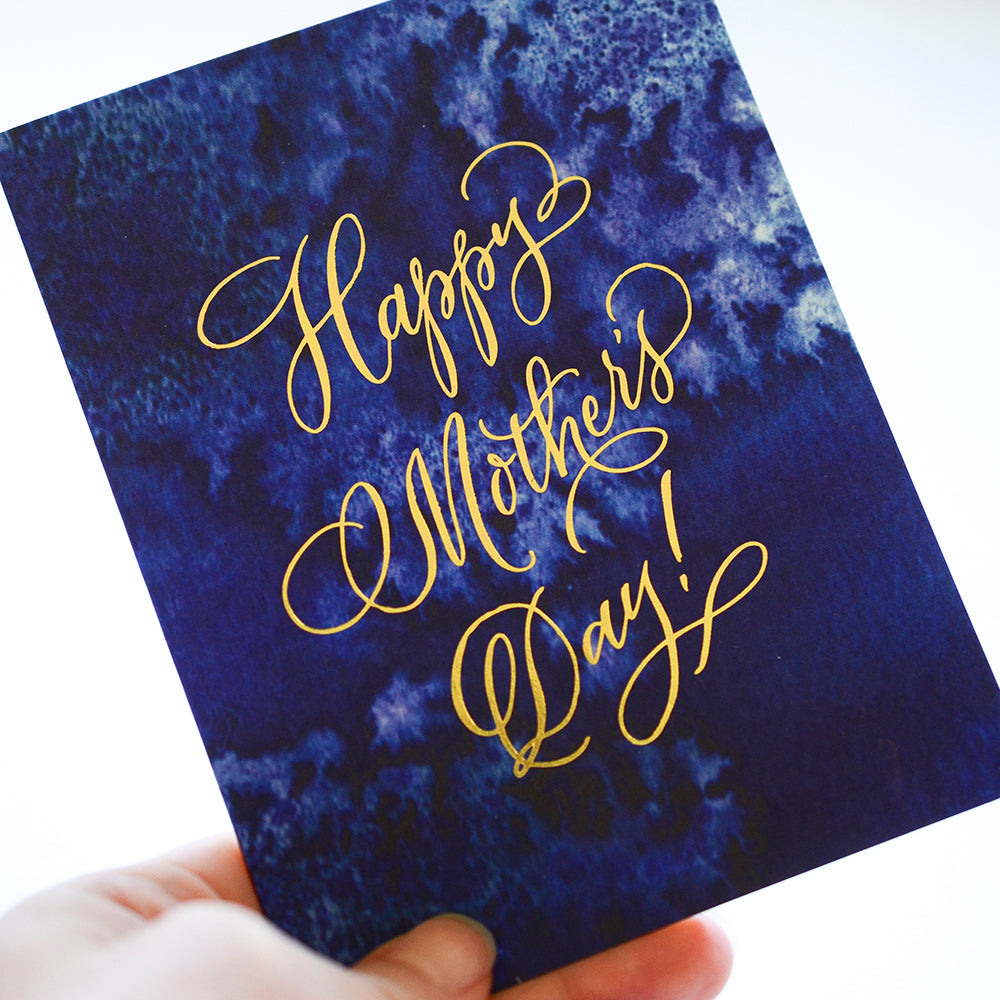 Indigo Mother's Day card with botanical indigo background and gold lettering, ideal for moms who love bold simple designs.