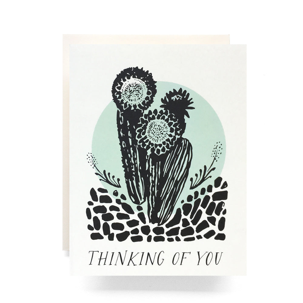 Illustration of cacti with bold 'Thinking of You' text on a blank sympathy card