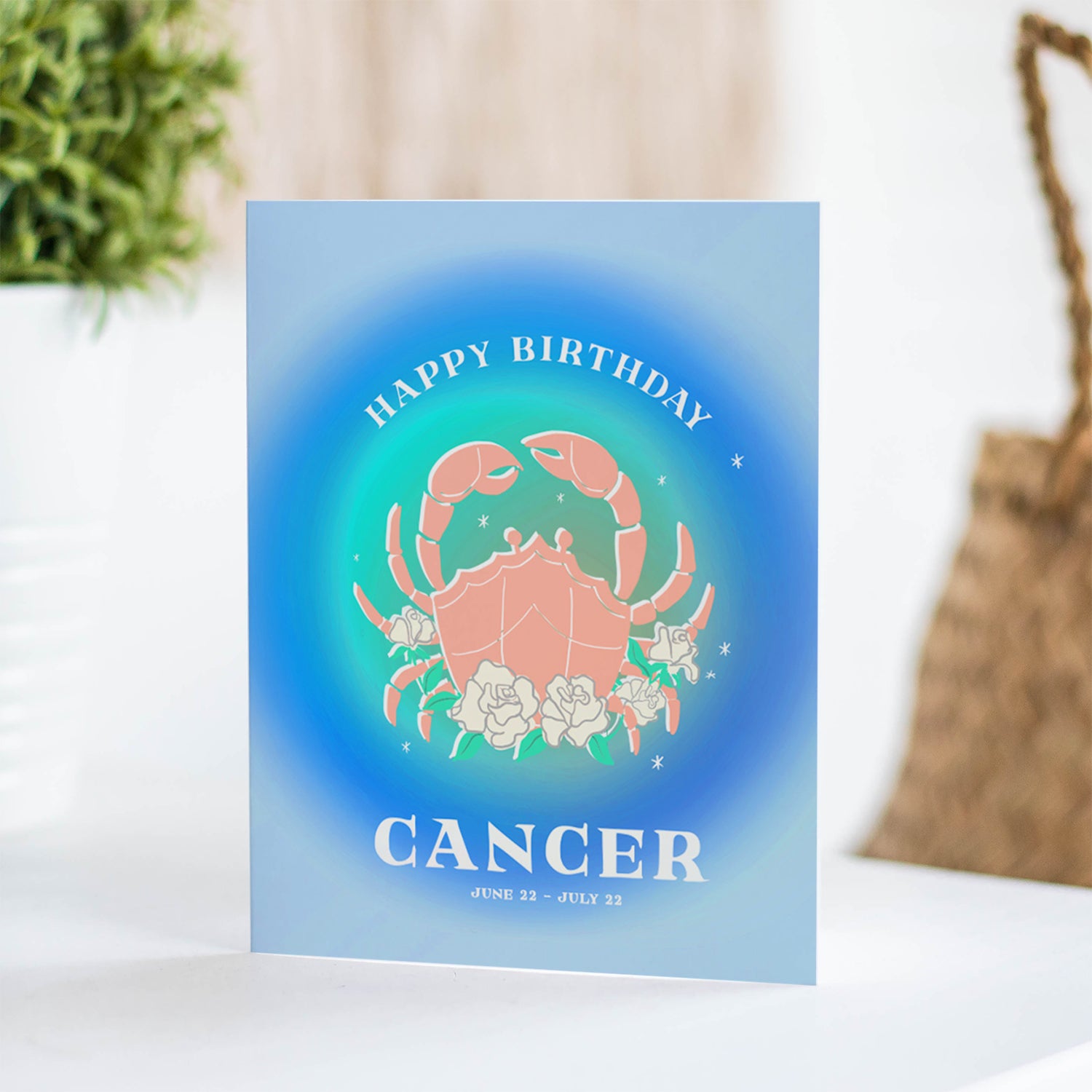 Soothing birthday card featuring the Cancer symbol with ocean-inspired blues and the crab symbol, celebrating Cancer's compassionate and intuitive energy.