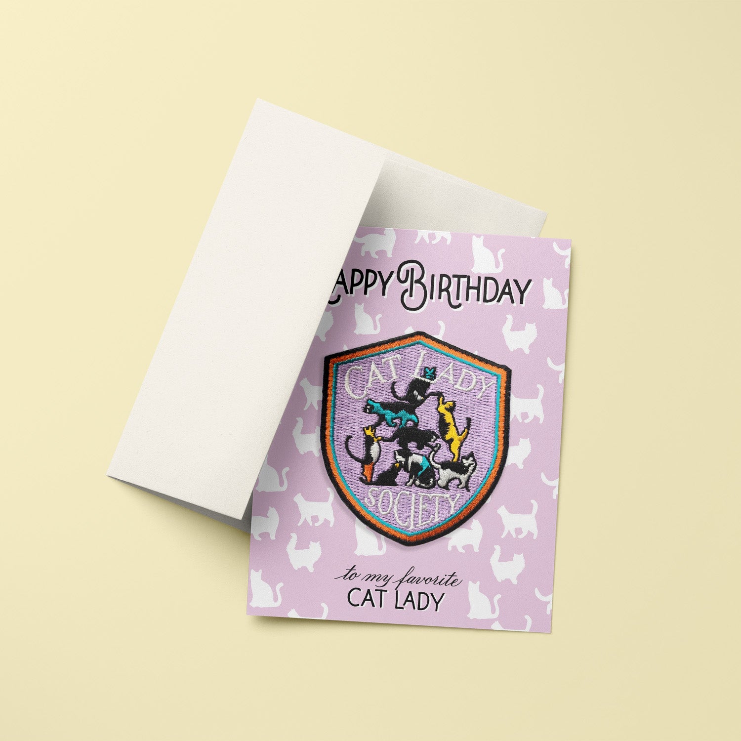 Playful birthday card with an iron-on 'Cat Lady' patch, adorned with cat illustrations, ideal for feline enthusiasts celebrating their special day.