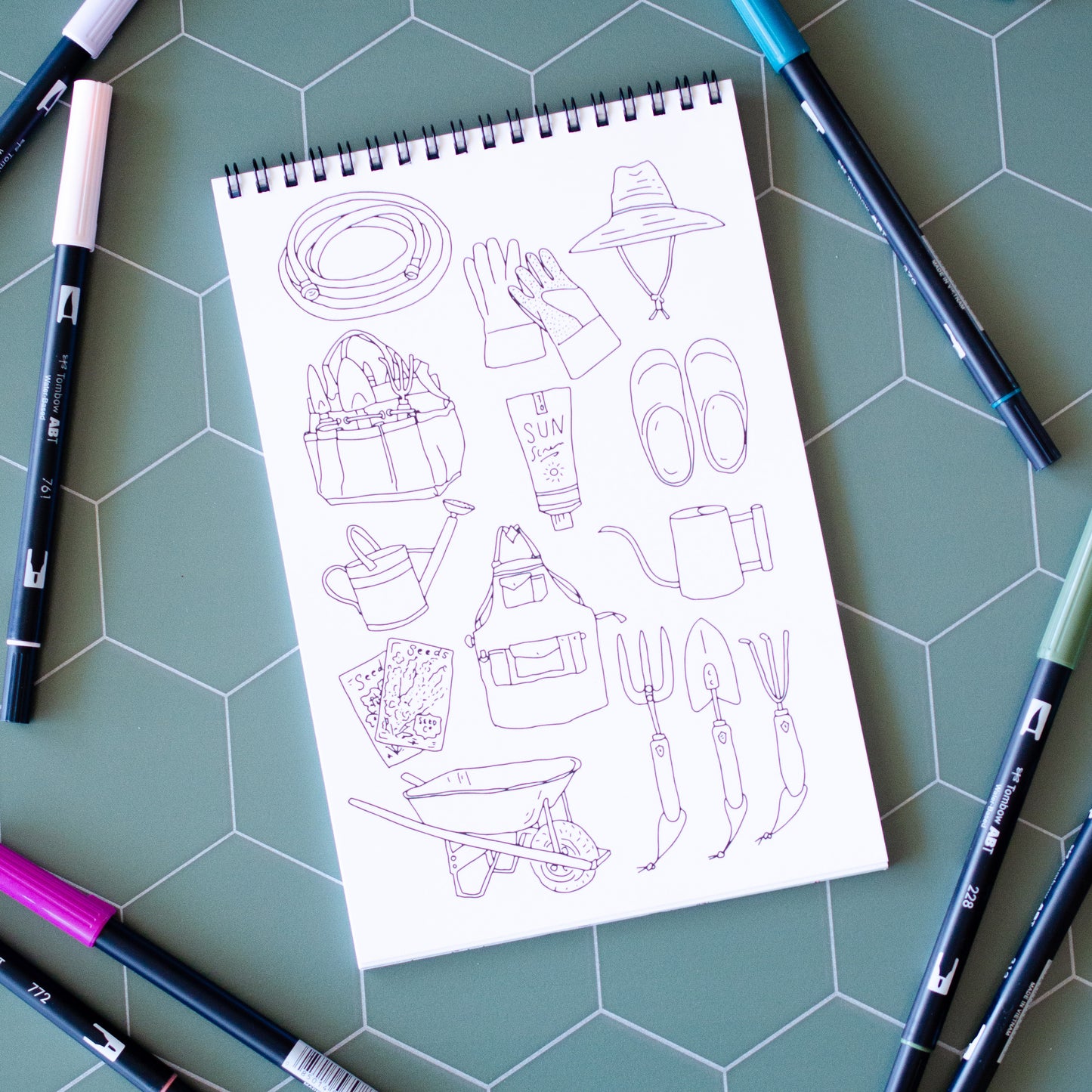 Cottage Garden Coloring Book with 22 pages of hand-drawn illustrations featuring flowers, bees, butterflies, and a whimsical garden gnome. Spiral-bound adult coloring book with intricate botanical designs, perfect for relaxation and creativity.