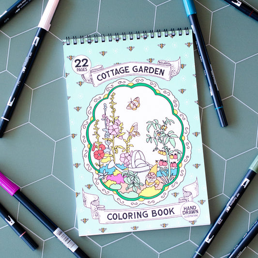 Cottage Garden Coloring Book with 22 pages of hand-drawn illustrations featuring flowers, bees, butterflies, and a whimsical garden gnome. Spiral-bound adult coloring book with intricate botanical designs, perfect for relaxation and creativity.