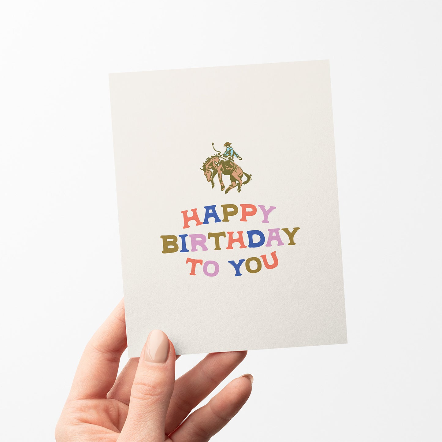 Birthday card with a cowboy riding a horse and colorful 'Happy Birthday To You' text