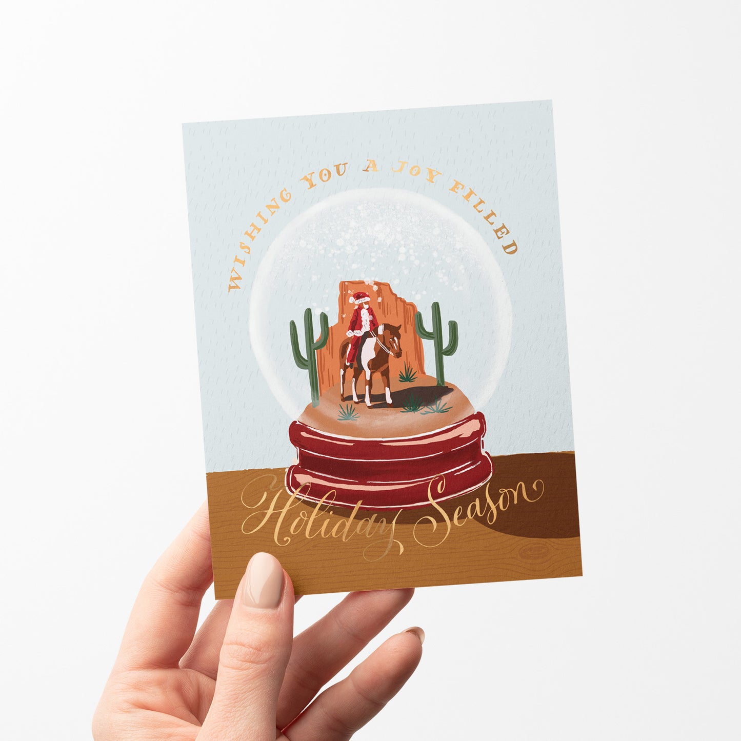 Cowboy Santa snowglobe holiday card, with a whimsical cowboy Santa inside a snowglobe, perfect for holiday fun, blank inside.