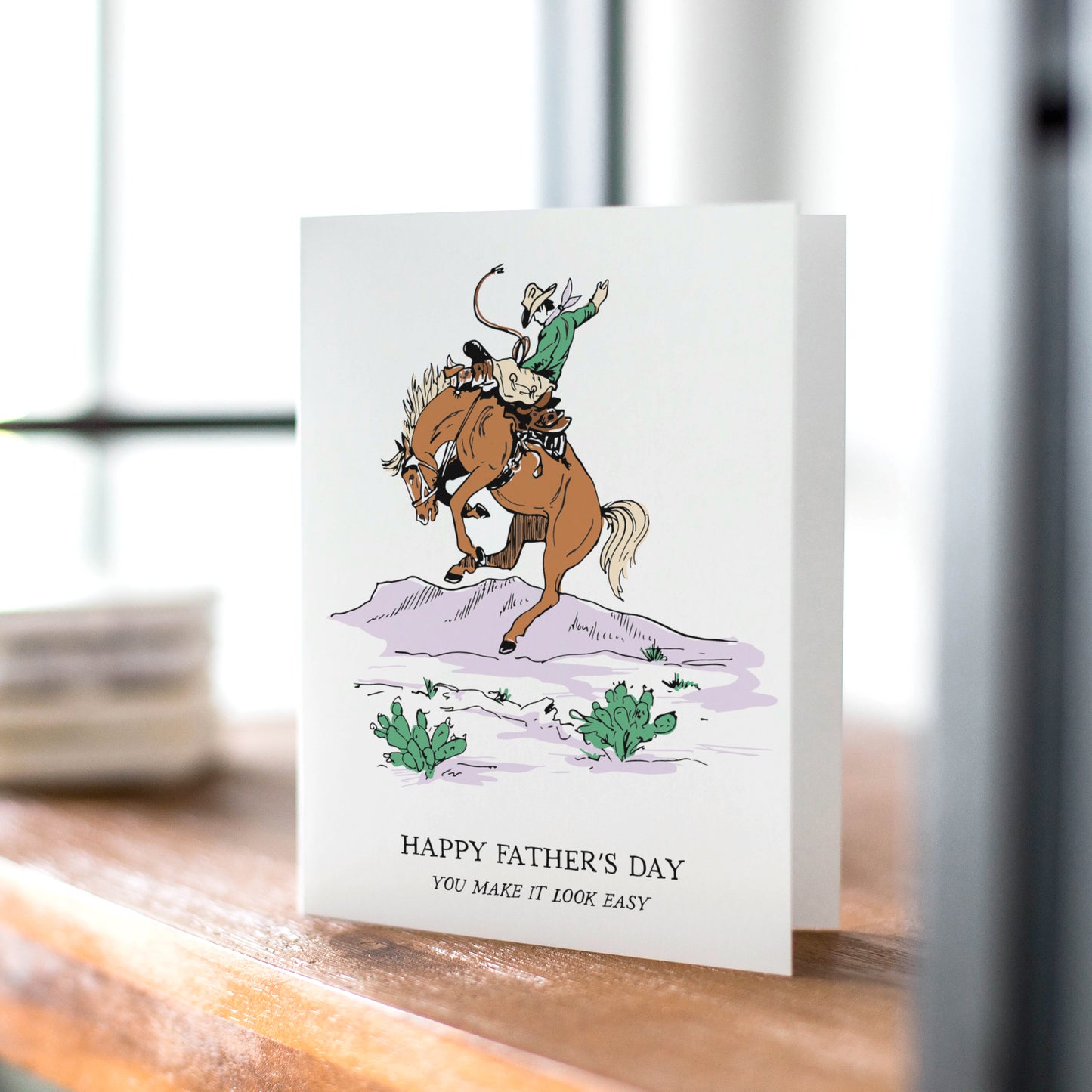 Bucking Bronc Father's Day card with a cowboy on a bucking bronco in a desert. Cowboy and rodeo theme, great for dads who enjoy western traditions