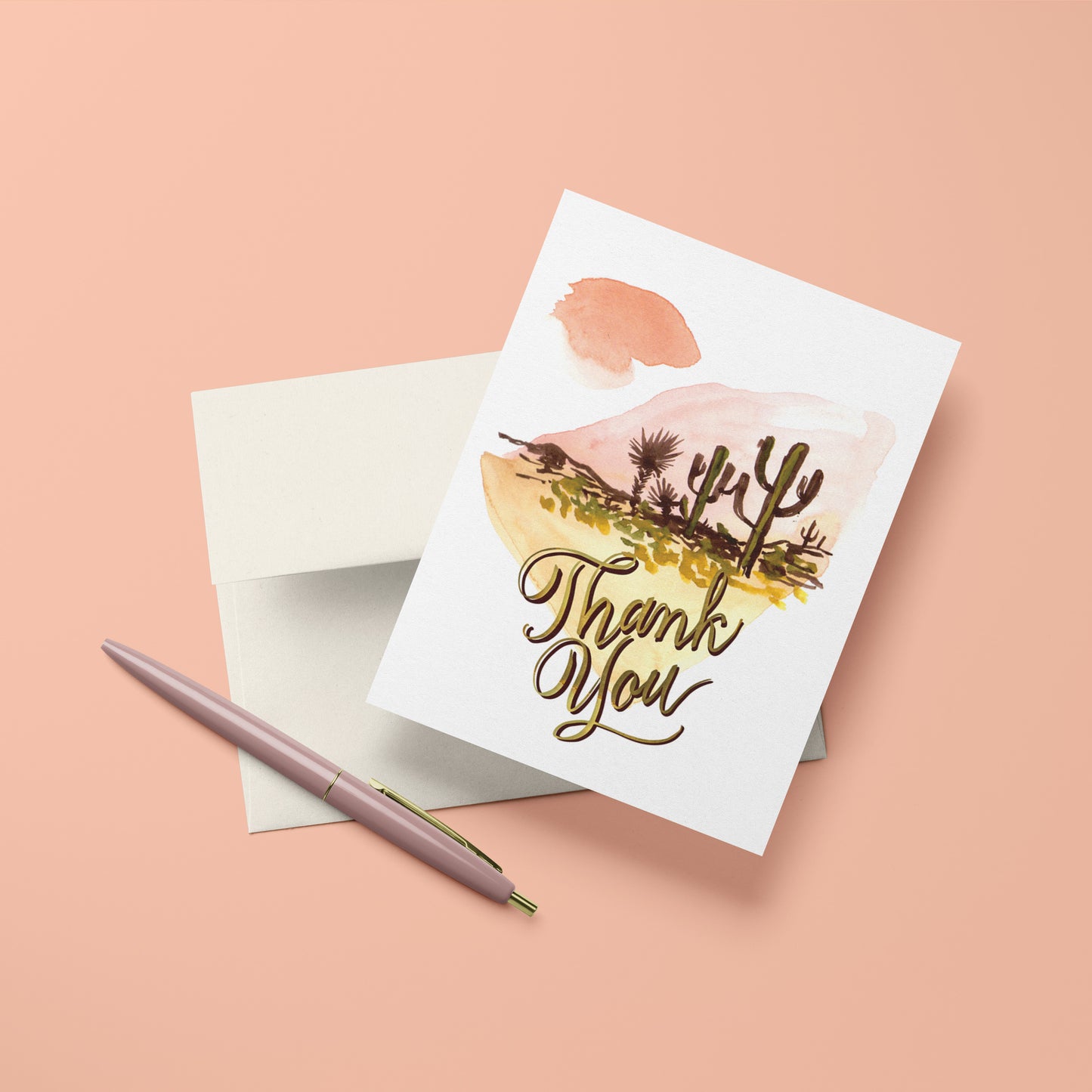 Thank you card with silhouette cacti in a desert land scape design on a backdrop of abstract watercolor.