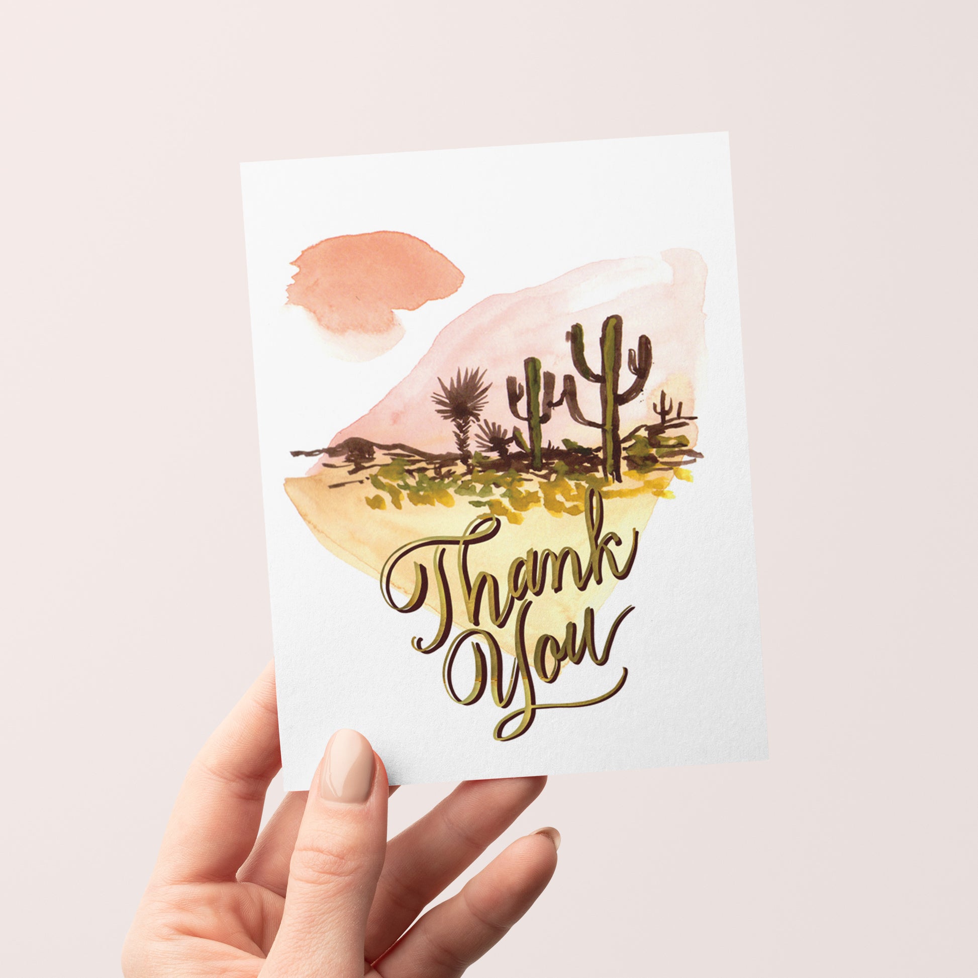 Thank you card with silhouette cacti in a desert land scape design on a backdrop of abstract watercolor.