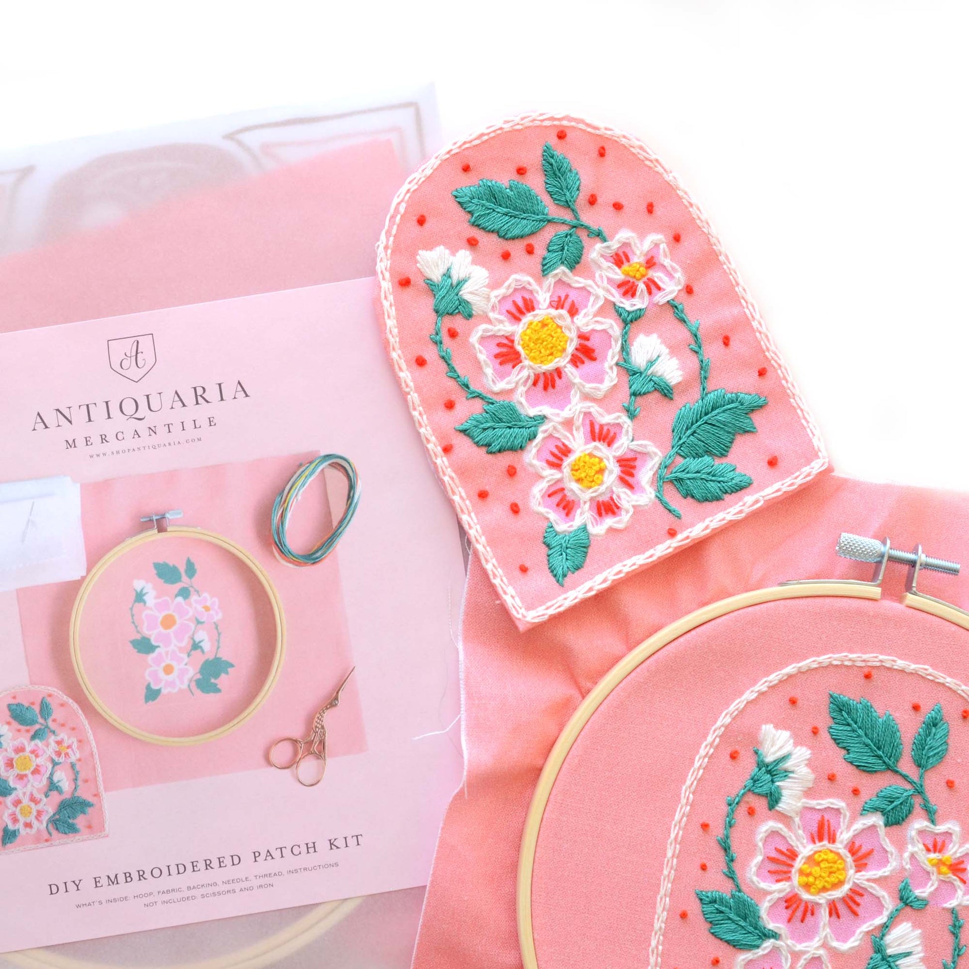 Embroidery patch kit with fabric, wooden hoop, thread, needle, and instructions for beginners, featuring beautifully illustrated roses