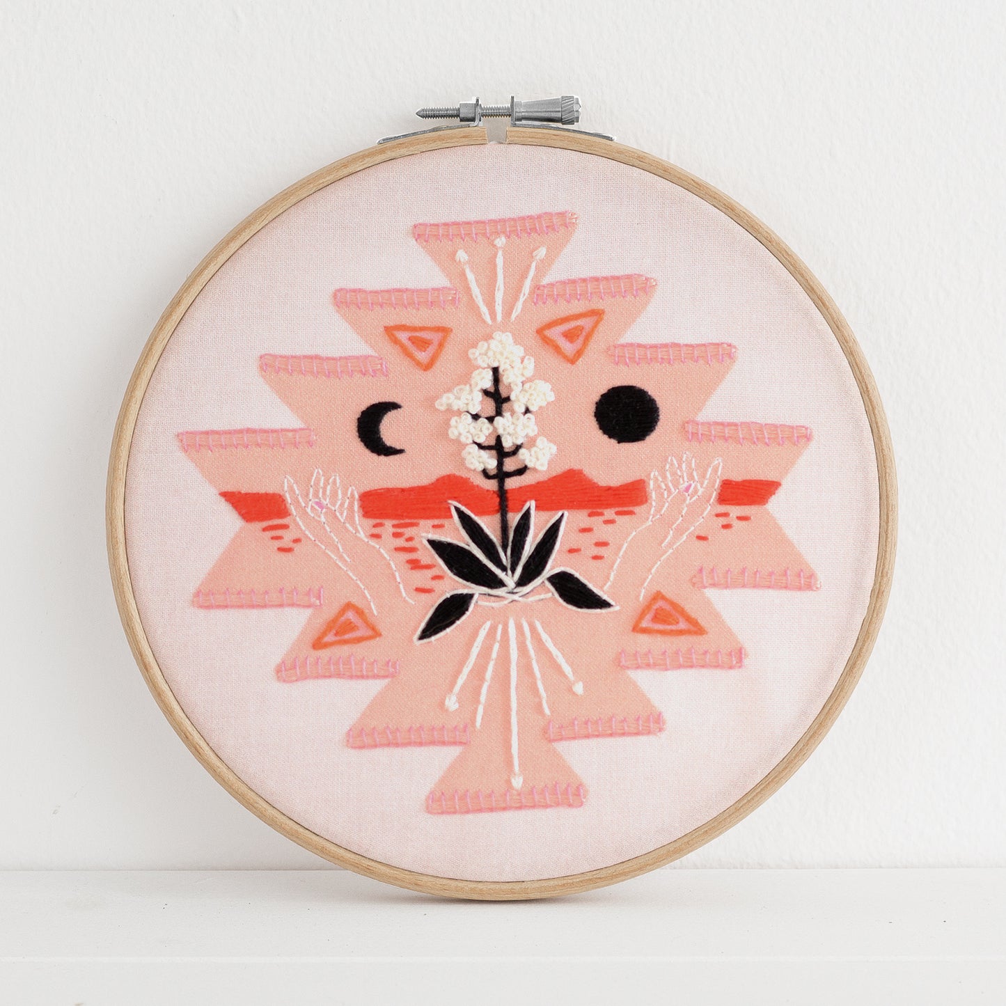 Embroidery kit with fabric, wooden hoop, thread, needle, and instructions for beginners, featuring a geometric desert scene