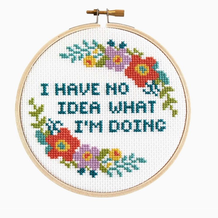 Cross stitch kit with fabric, wooden hoop, thread, needle, and instructions for beginners, saying "I have no idea what I'm doing".