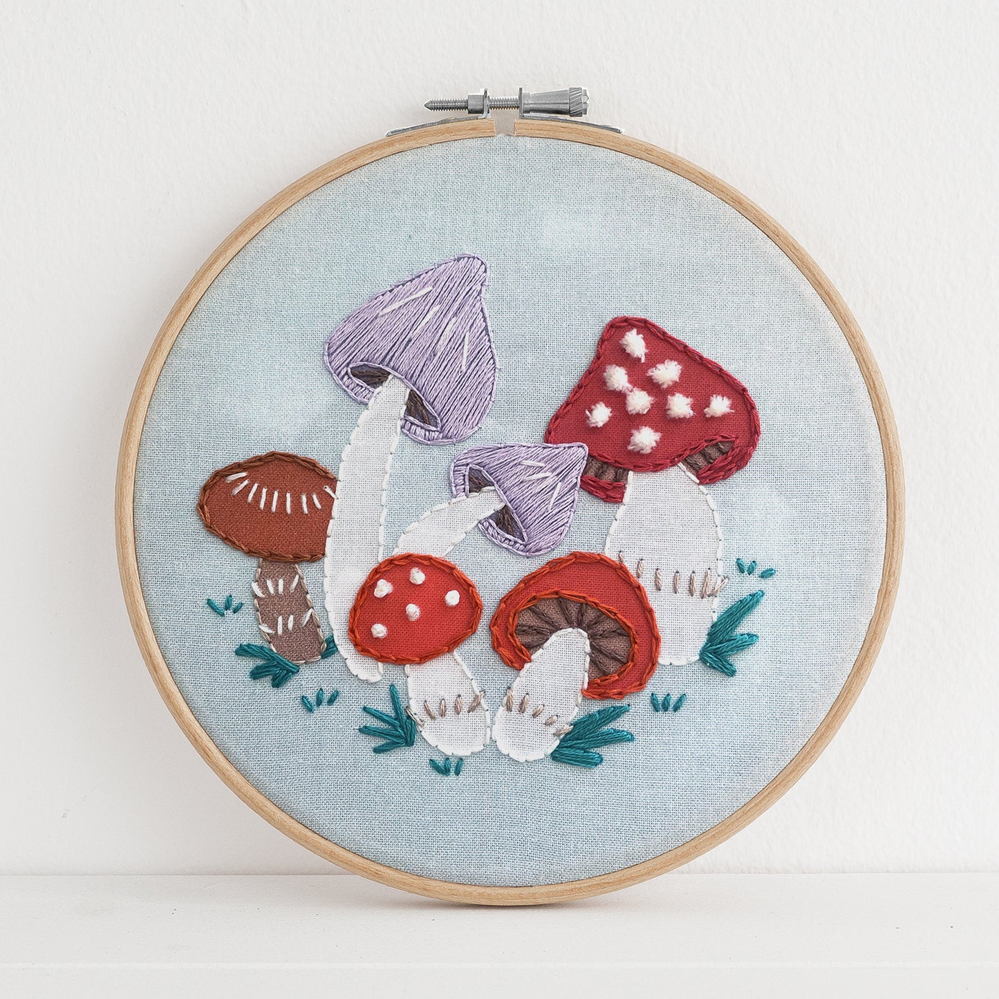 Embroidery kit with fabric, wooden hoop, thread, needle, and instructions for beginners, featuring cute fox surrounded by different flora and fauna 