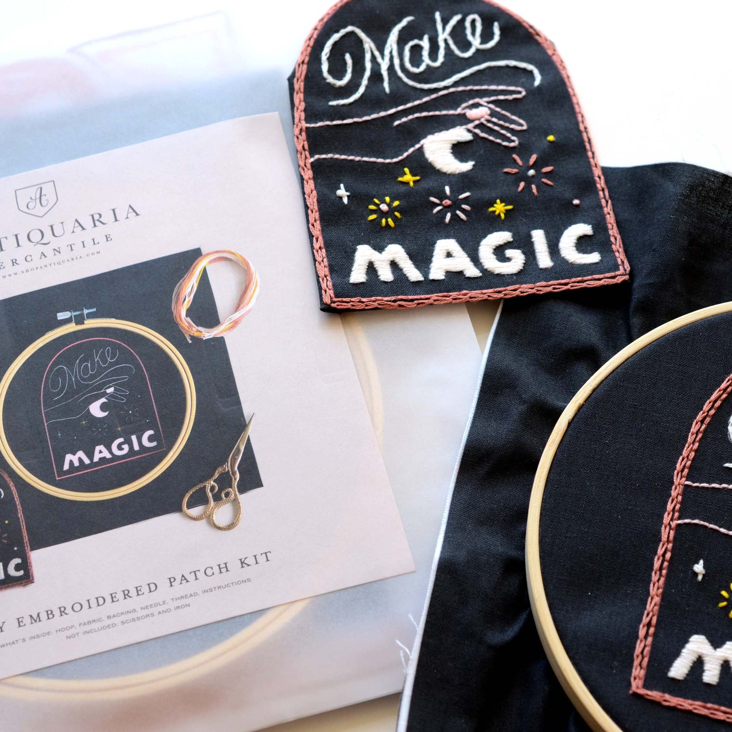 Embroidery patch kit with fabric, wooden hoop, thread, needle, and instructions for beginners, a stary sky in a hand with the saying "make magic"