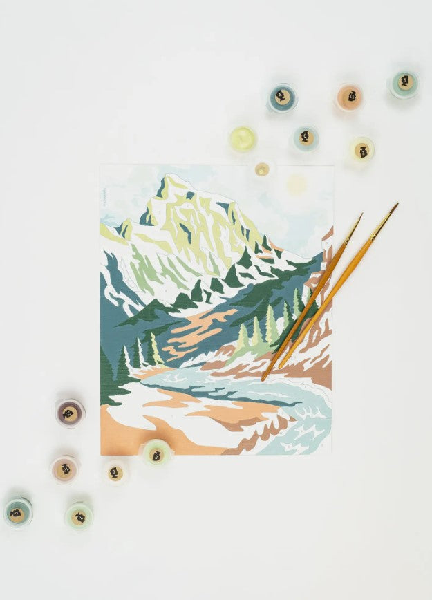 Paint by number kit featuring a a beautiful mountain scape, includes canvas, paint set, and brushes."