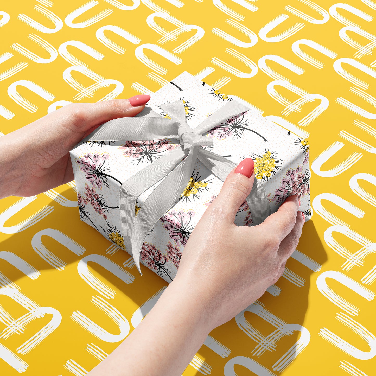 Sustainable gift wrap with delicate florals on one side and geometric patterns on the other, perfect for any occasion. 100% recyclable and compostable