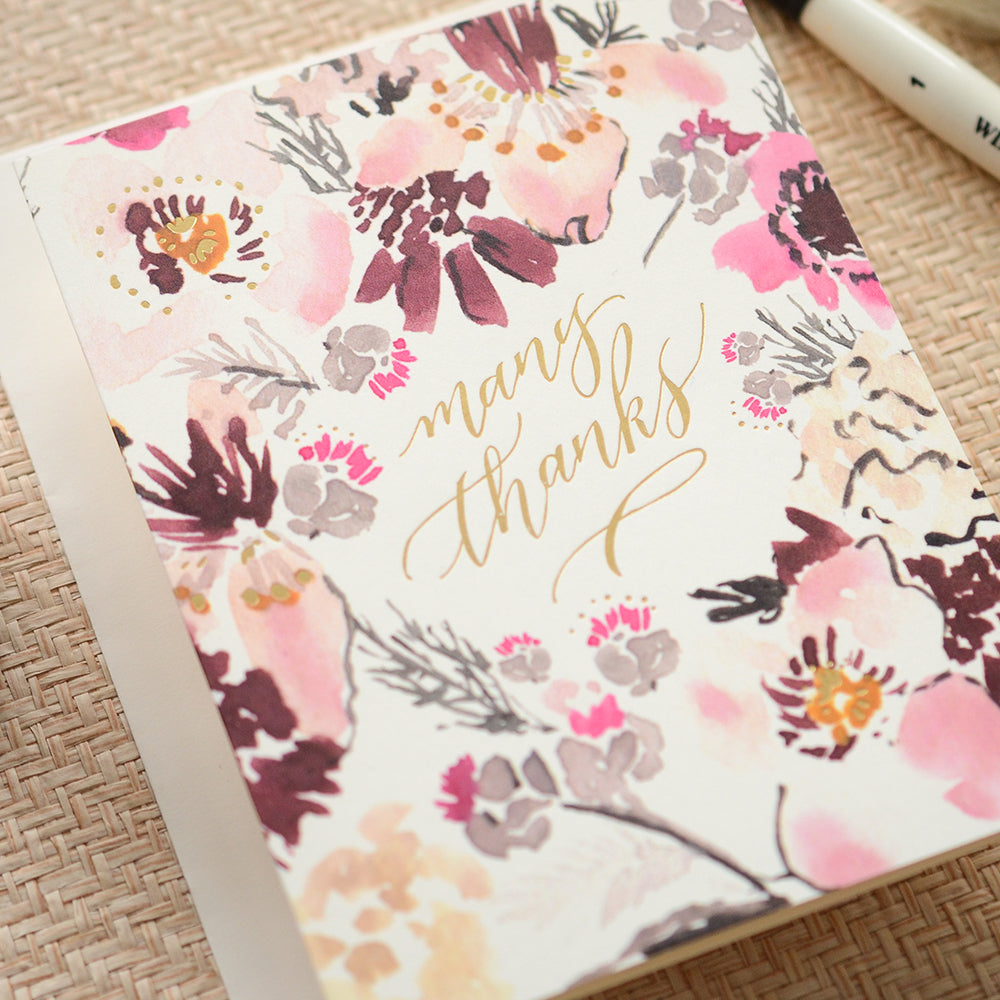 Thank you card with a vibrant watercolor floral design and 'Many Thanks' in gold script.